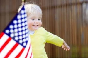 Cute toddler boy with american flag