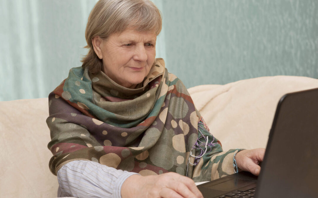 Portrait of senior woman using laptop, looking at screen