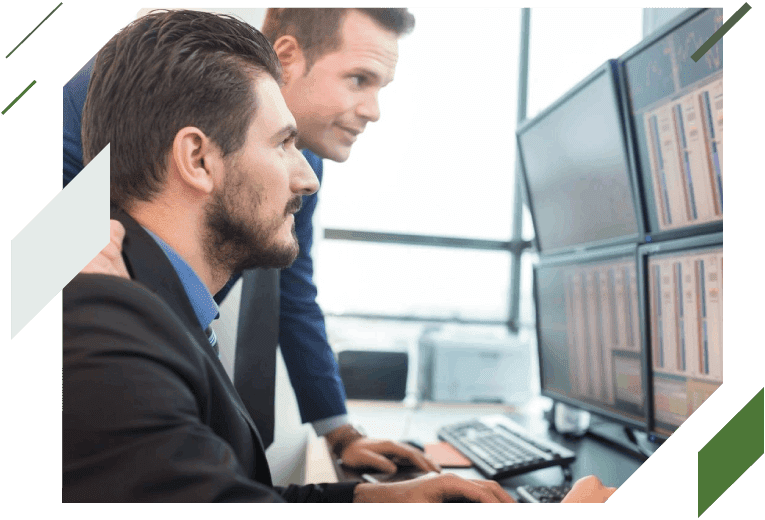 Two men in suits looking at a computer screen.