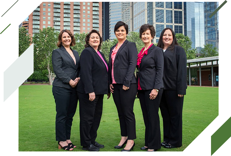 A group of women in suits standing on top of a green field.