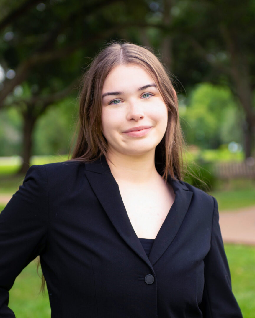 Female business professional wearing black business suit.